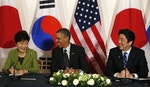 Obama holds a tri-lateral meeting with Park and Abe after the Nuclear Security Summit in The Hague