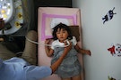 A doctor conducts a thyroid examination on four year old Maria Sakamoto  brought by her mother to the office of Iwaki Radiation Citizen Centre NPO in Iwaki town