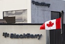 A Canadian flag waves in front of a Blackberry logo at the Blackberry campus in Waterloo
