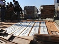 A Paraguayan police officer lays out packets of cocaine, discovered by anti-drug and customs police in a shipment of wood flooring that they say was bound for Italy, in the cargo area of Caacupemi Por