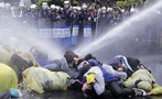 Police use water cannon to disperse demonstrators protesting construction of fourth nuclear plant, in front of Taipei Railway station in Taipei