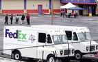 Fed-Ex employees and friends wait at a staging area at a skating rink after a shooting at a FedEX Corp facility at an airport in Kennesaw