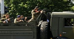 Pro-Russian rebels atop truck drive towards Donetsk airport