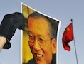 劉曉波 A protester holds an image of to jailed dissident Liu outside of the Chinese Embassy in Oslo