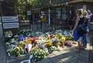 A mother and her daughter reflect at the gate of the Korporaal van Oudheusden barracks, after bringing flowers to remember the victims killed in Malaysia Airlines Flight MH17 plane disaster, in Hilver