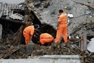Rescue personnel survey the wreckage of a TransAsia Airways turboprop plane that crashed, on Penghu island