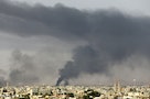 Black plumes of smoke is seen in the vicinity of Camp Thunderbolt, after clashes between militants, former rebel fighters and government forces in Benghazi