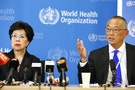 WHO Director-General Margaret Chan sits next to Fukuda, WHO's assistant director general for health security, as he addresses the media in Geneva