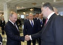 Russian President Vladimir Putin shakes hands with his Ukrainian counterpart Petro Poroshenko in Minsk