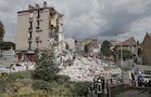 French firefighters search the rubble of a collapsed building in Rosny-Sous-Bois