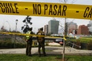 Police officers are seen behind barricade tape guarding an area where a bomb exploded in Santiago