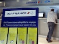 A passenger waits at a check-in counter on the first day of an Air France one-week strike at Nice International airport