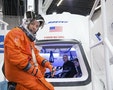 NASA astronaut Randy Bresnik prepares to enter Boeing's CST-100 spacecraft for a fit check evaluation at the company's Houston Product Support Center