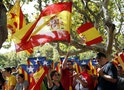 Catalonian separatist supporters and Spanish unionist supporters wave flags in front of Catalonia's Parliament before the approval of a regional consultation law in Barcelona