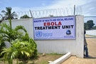 A man stands at the gate of an Ebola virus treatment center in Monrovia