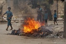 Residents gather and burn trash in Ashrafieh, Aleppo