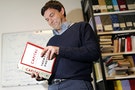 Thomas Piketty, French economist and academic, poses in his book-lined office at the French School for Advanced Studies in the Social Sciences (EHESS), in Paris