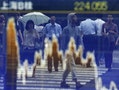 Passers-by are reflected on a graph showing movements of Shanghai B shares outside a brokerage in Tokyo