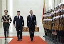 Xi walks next to Obama as they inspect the honour guards during a welcoming ceremony at the Great Hall of the People in Beijing