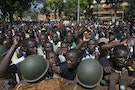Anti-government protesters chant slogans in front of army headquarters in Ouagadougou