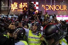 A riot police officer holds a baton as he confronts pro-democracy protesters in Mongkok