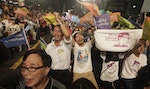 Supporters wave flags after Taipei mayoral candidate Ko Wen-je won the local elections, in Taipei