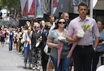 Members of the public form a long queue as they prepare to lay floral tributes to the victims of the Sydney cafe siege in Martin Place