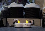 Coffee cups featuring images of the two victims who died in the Sydney cafe siege, lawyer Katrina Dawson and Lindt store manager Tori Johnson are pictured at a makeshift memorial before sunrise in Martin Place