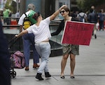Iranian-born Maral offers 'free hugs'  to members of the public during a public outpouring of emotion after the Sydney cafe siege