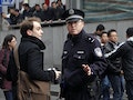 A policeman asks a foreign journalist to leave the area near the Peace Cinema, after calls for a "Jasmine Revolution" protest, organised through the internet, in downtown Shanghai