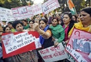 Members of All India Mahila Congress, women's wing of Congress party, shout slogans and carry placards during a protest against the rape of a female passenger, in New Delhi