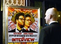 A security guard stands at the entrance of United Artists theater during the premiere of the film "The Interview" in Los Angeles