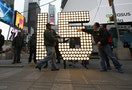 Strauss, president of Countdown Entertainment, lights the New Year's Eve "15" numerals in a ceremony after they were unloaded from truck in Times Square in New York