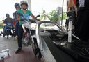 An employee of state-owned Pertamina refuels a motorcycle at its petrol station in Jakarta