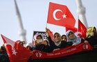 Supporters of the Gulen movement wave Turkish flags as they gather outside the Justice Palace in Istanbul