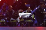 Paramedics remove a person, with bloodstains on the blankets covering the person, on a stretcher from the Lindt cafe at Martin Place in central Sydney