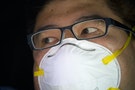 A man wears a surgical mask in the China Town neighborhood of New York