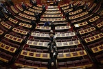 Greek lawmakers leave the hall after the second of three rounds of a presidential vote at the Greek parliament in Athens