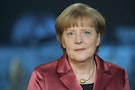 Merkel poses after recording her New Year's speech in the Chancellery in Berlin
