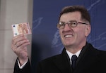 Lithuania's Prime Minister Butkevicius holds euro banknote during an event celebrating Lithuania's joining the euro zone in Vilnius