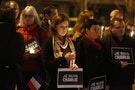 People hold a vigil for the victims of the shooting at the Paris offices of the publication Charlie Hebdo outside the French consulate in Seattle, Washington