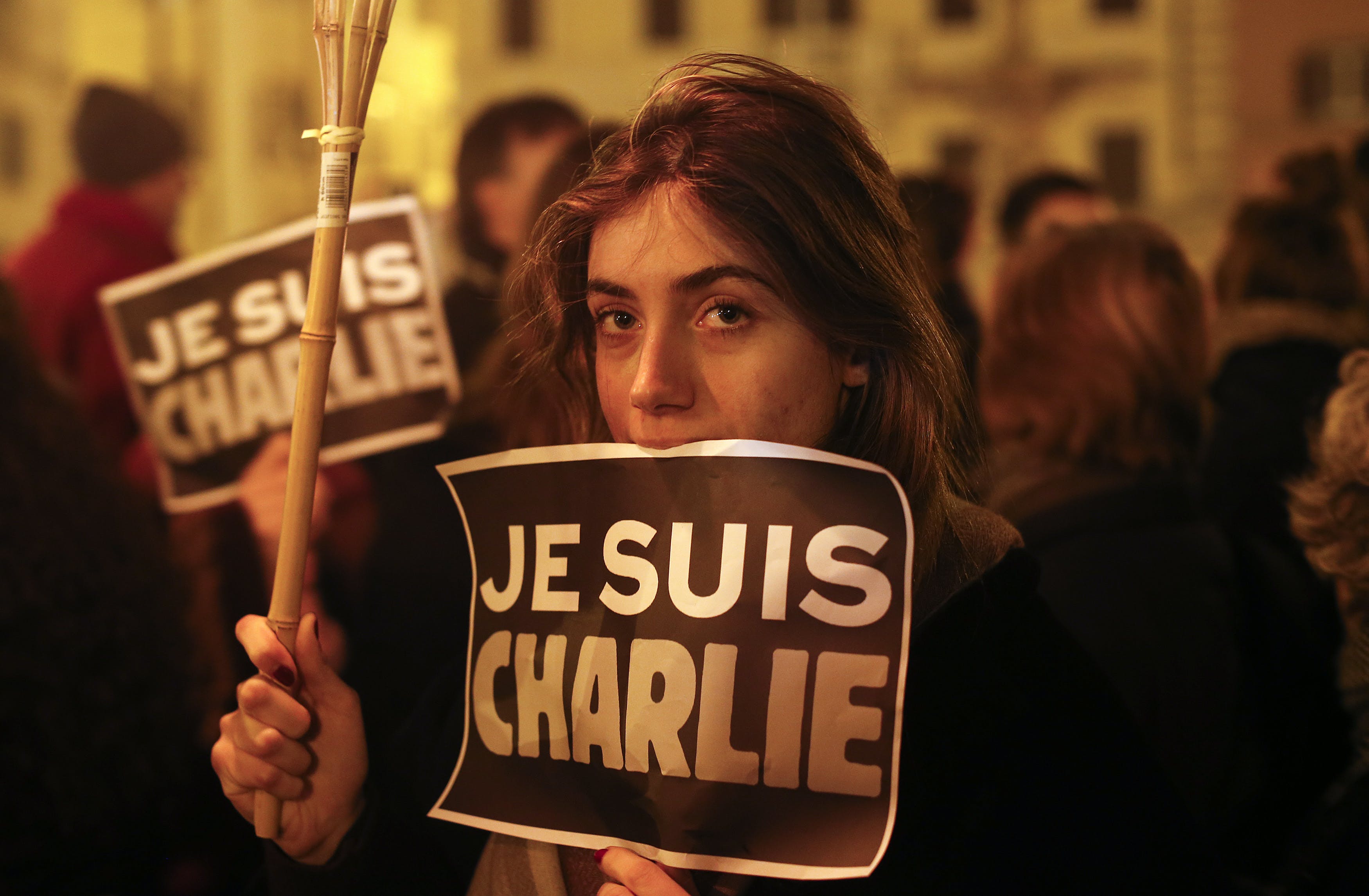 A woman holds a placard reading "I am Charlie" to pay tribute to the victims following a shooting by gunmen at the offices of weekly newspaper Charlie Hebdo in Paris in front of the French embassy in 