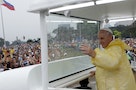 Pope Francis waves from the popemobile before leading a Mass at Rizal Park in Manila