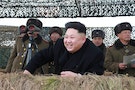 North Korean leader Kim Jong Un laughs as he watch a winter river-crossing attack drill of the armored infantry sub-units of the motorized strike group in the western sector of the front of the KPA