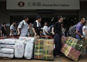 Chinese visitors at Hong Kong train station line up with instant noodles and diapers to be parallel imported into Shenzhen