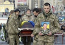 Ukrainian soldiers carry the coffin bearing the body a member of self-defence battalion "Aydar" during a funeral ceremony at Independence Square in central Kiev