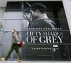 A pedestrian walks past advertisment for film 'Fifty Shades of Grey'  in Berlin