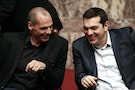 Greek PM Tsipras and Finance Minister Varoufakis smile during the first round of a presidential vote at the Greek parliament in Athens