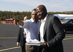 U.S. President Barack Obama talks to Reggie Love as he arrives in Asheville