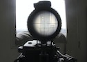 A view seen through the scope of a weapon belonging to a sniper and rebel fighter shows a building where forces loyal to Syria's President Bashar al-Assad are stationed, as seen from Al Waer